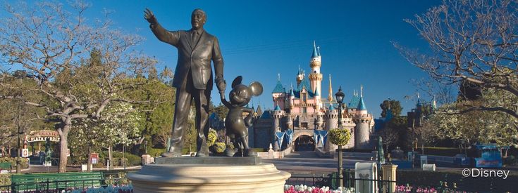 Statue of Walt Disney holding hands with Mickey Mouse in front of castle at Disneyland. Statue of Walt Disney holding hands with Mickey Mouse in front of castle at Disneyland.